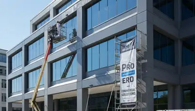 Professional commercial painters working on an office exterior in Olathe, KS