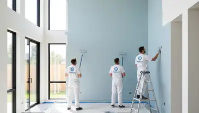 Professional interior house painters working in Olathe, KS living room with quality finishes