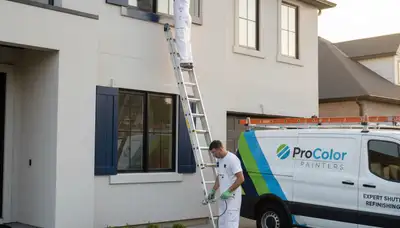 Professional painters refinishing exterior shutters in Olathe, KS home for improved curb appeal